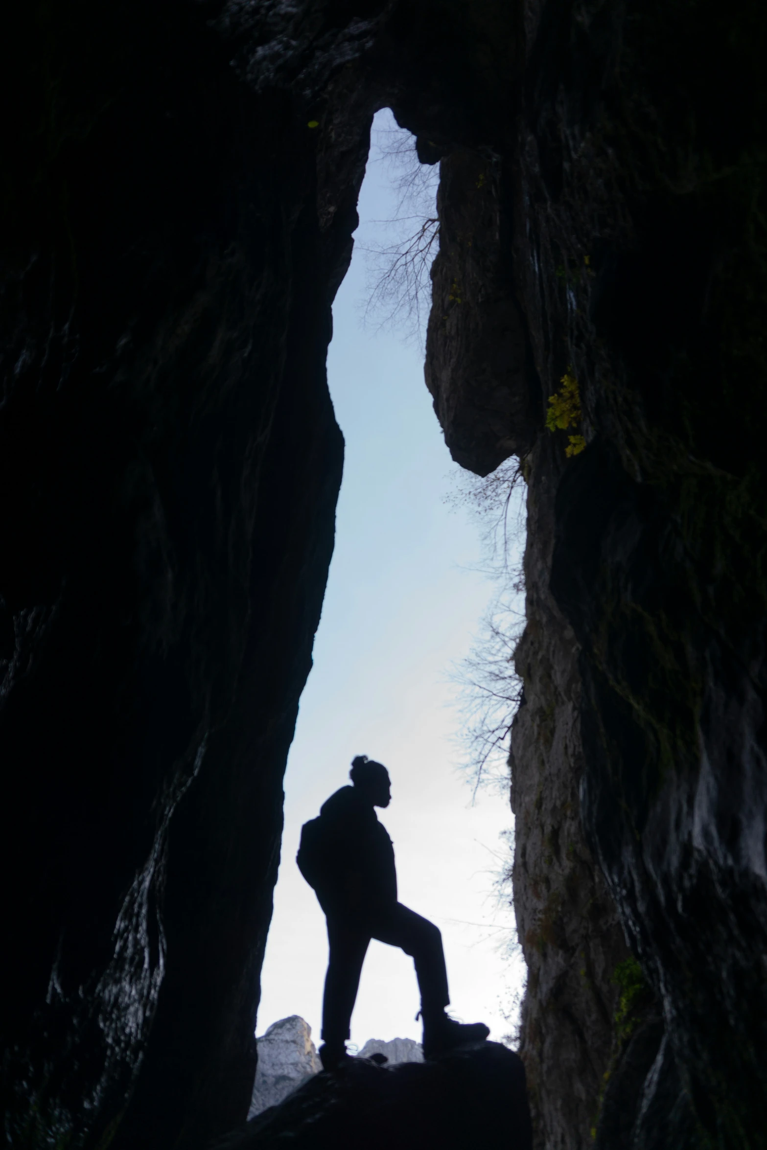 a person in an cave is looking at the sky