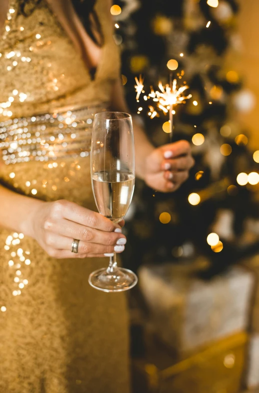 a close up of a person holding a wine glass