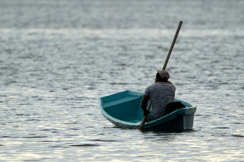 a man riding on a small boat in the water