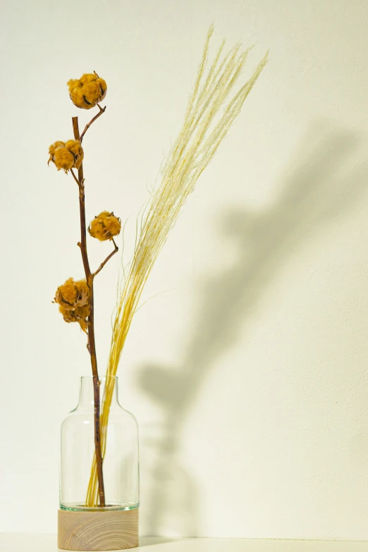 some flowers in a vase and water on a table