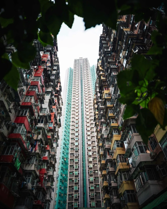 some very tall buildings with many balconies in the foreground