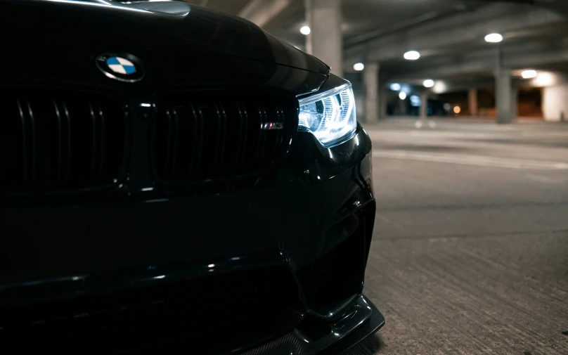 black bmw car sitting in an empty parking garage