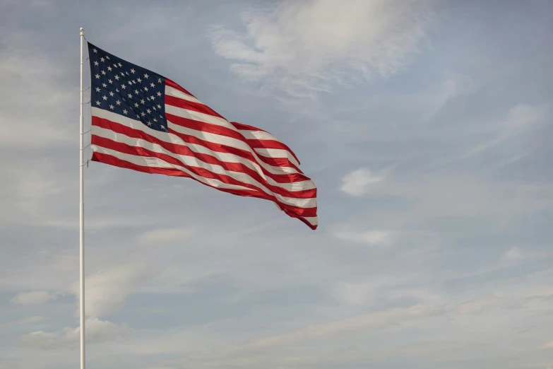 an american flag flies high in the air
