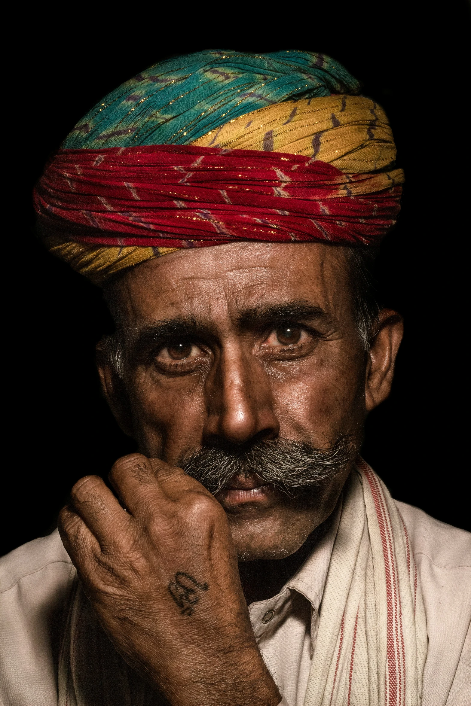 a man that is wearing a colored head piece