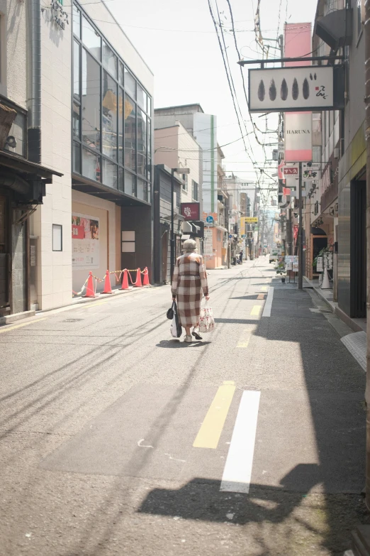 an image of a person walking down the street on a scooter