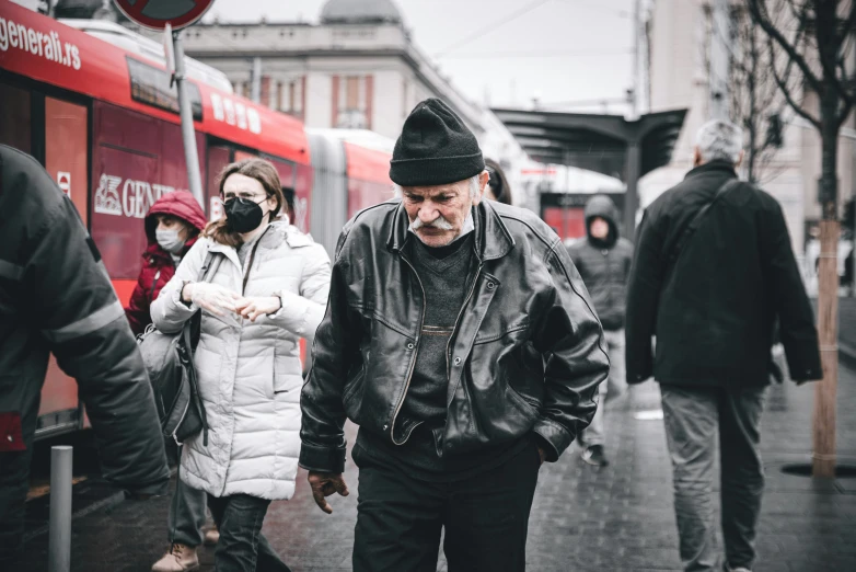 a man standing on a street corner talking on a cell phone