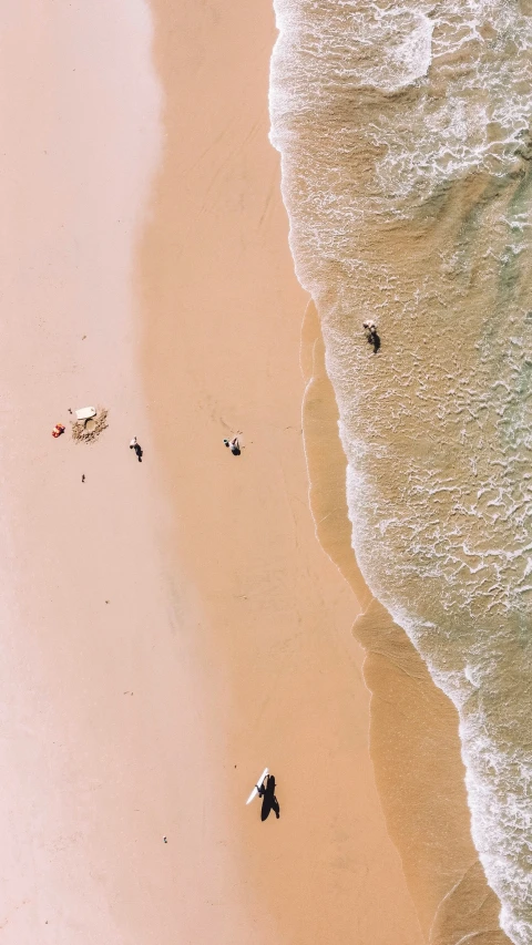 a picture from the air that shows several beachgoers on the beach