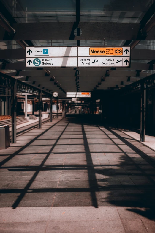 an empty subway station with directional signs