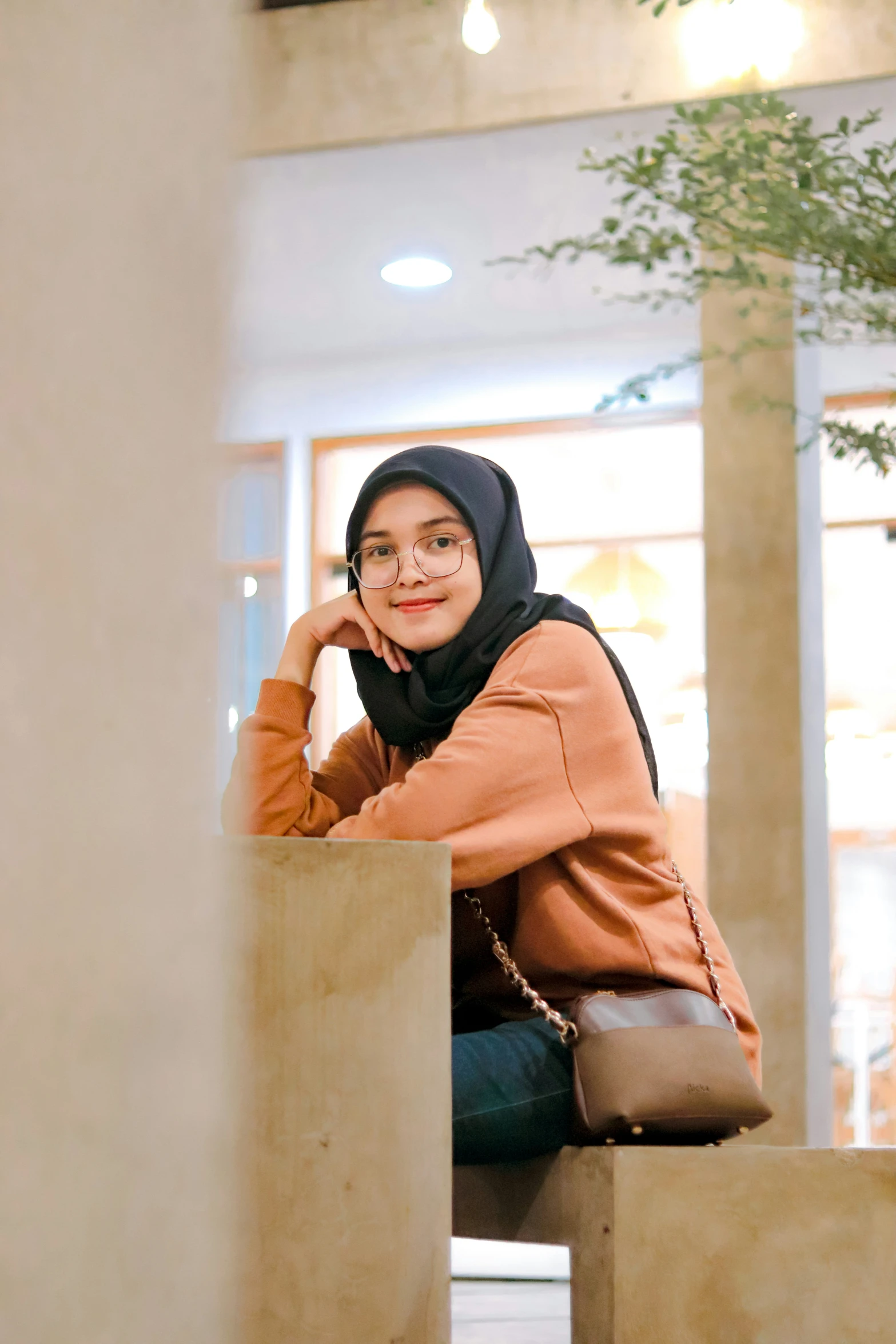 the woman is sitting in an architectural area