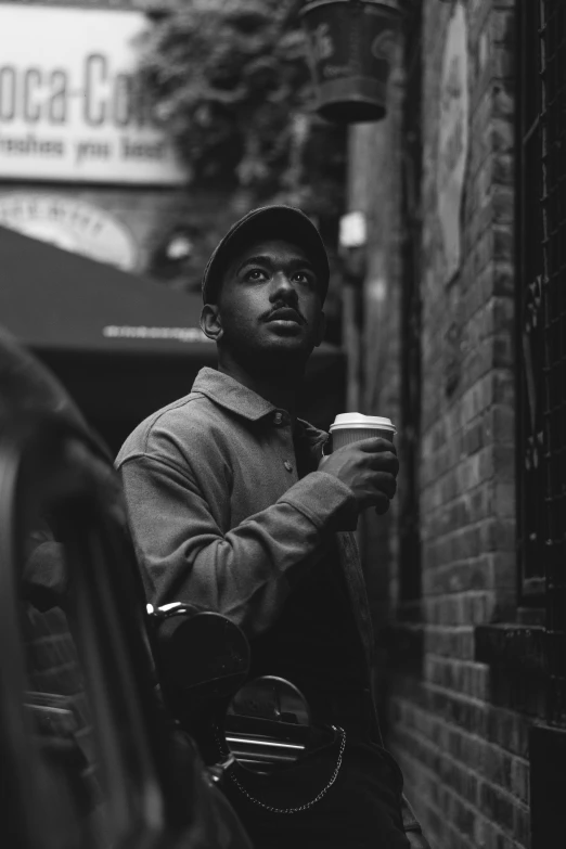 a black and white po of a man sitting on a bench