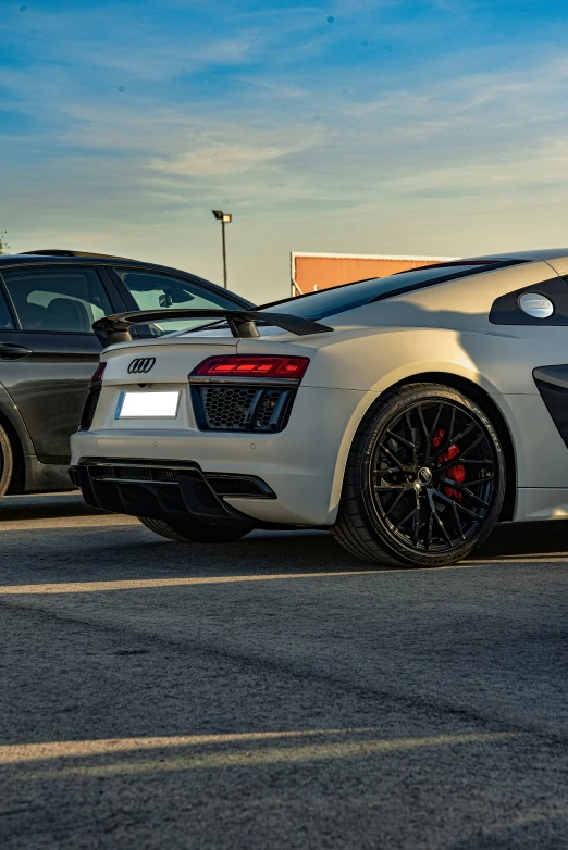 two silver sports cars parked in a parking lot