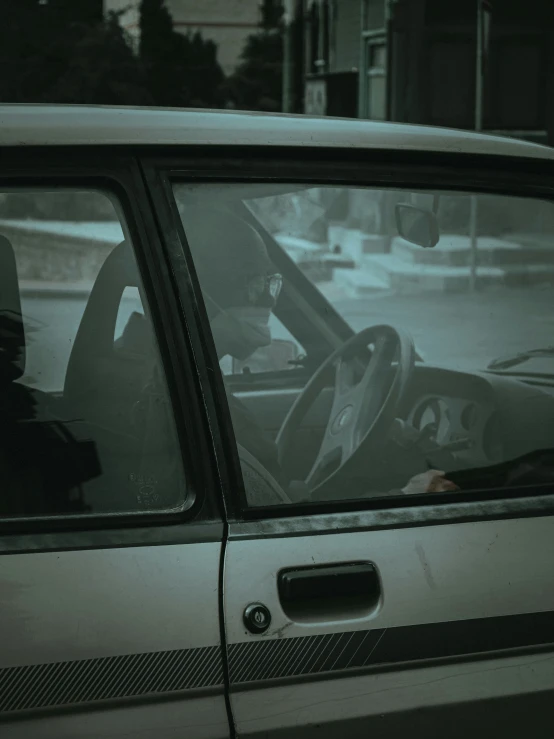 a man that is sitting in the driver seat of a car