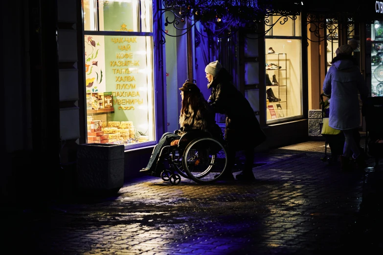 a man in a wheelchair next to another man