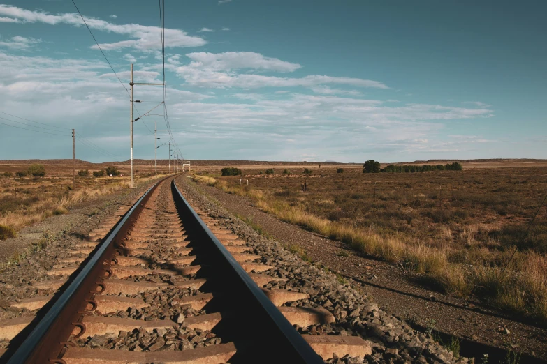 a train track running through a dry landscape