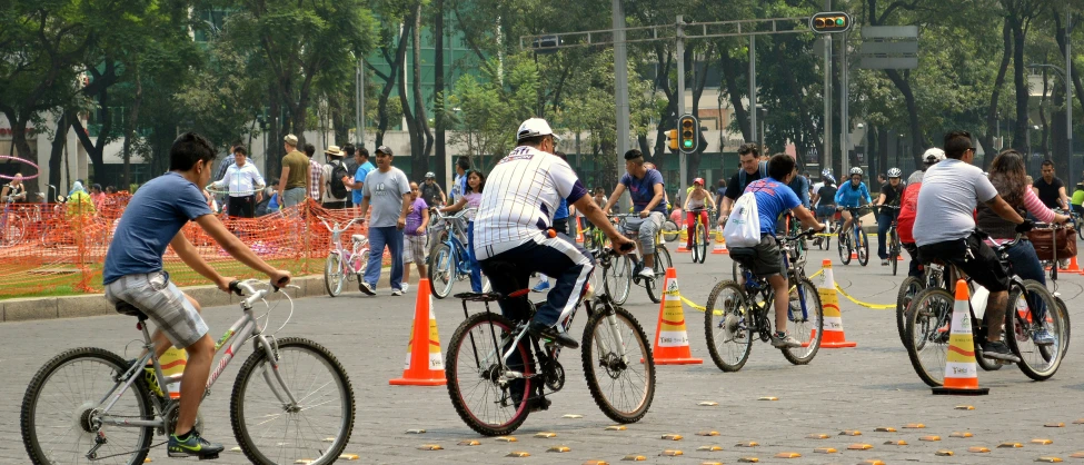 the bicyclists are competing through cones as part of an obstacle course