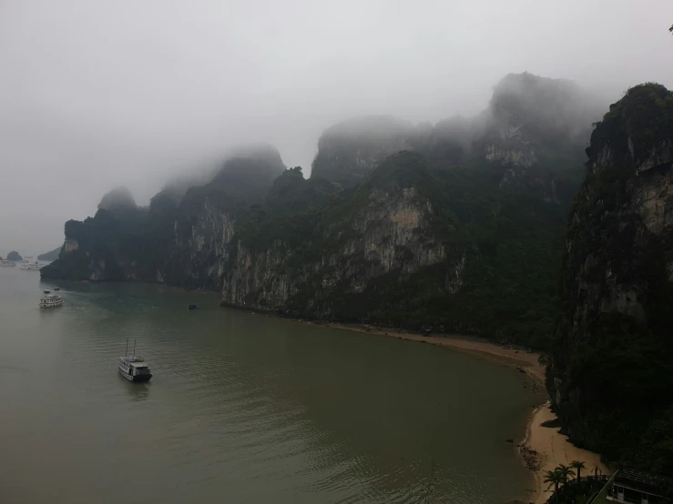 some boats are in the water and some mountains