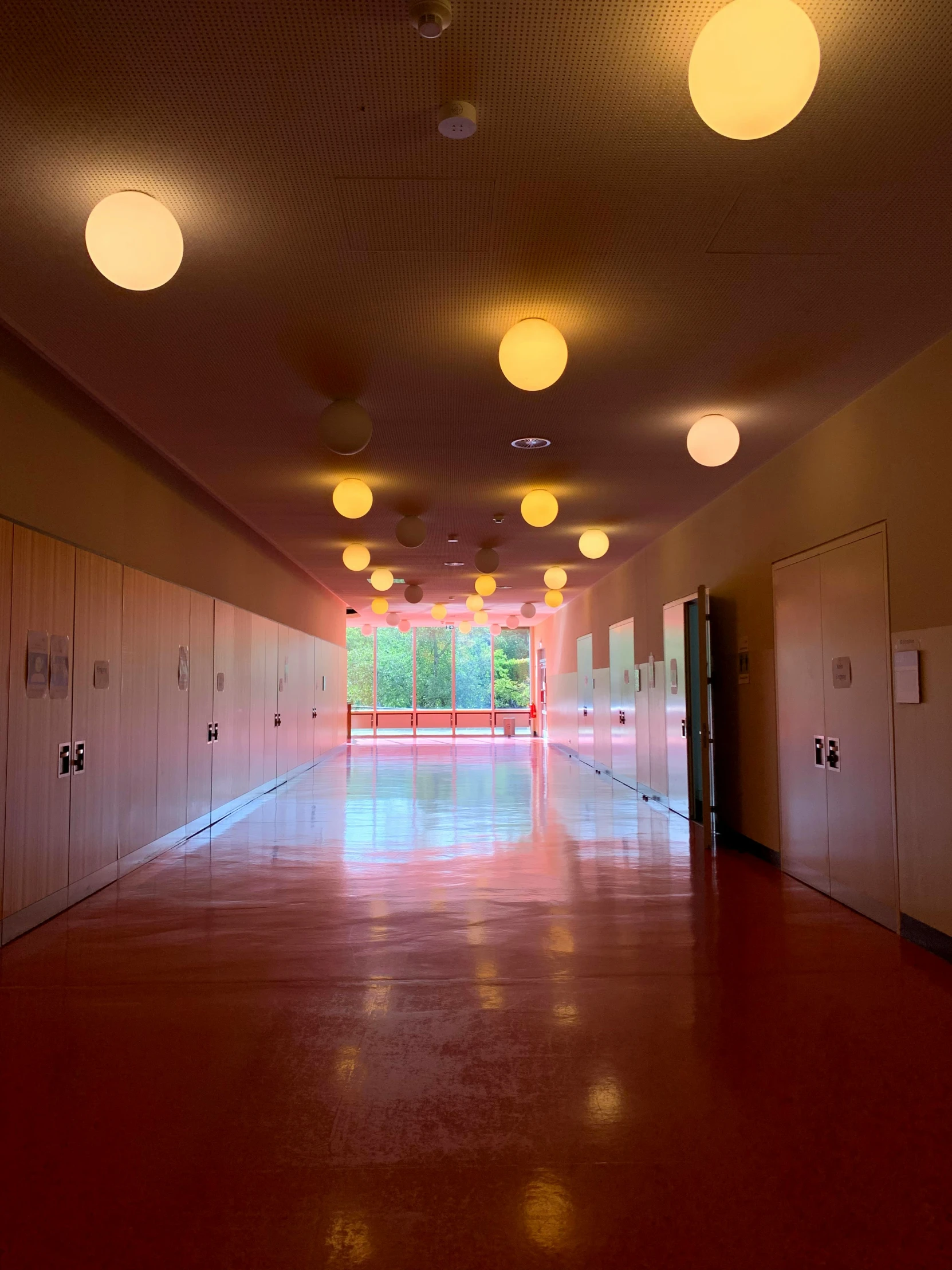 an empty hallway with many light fixtures