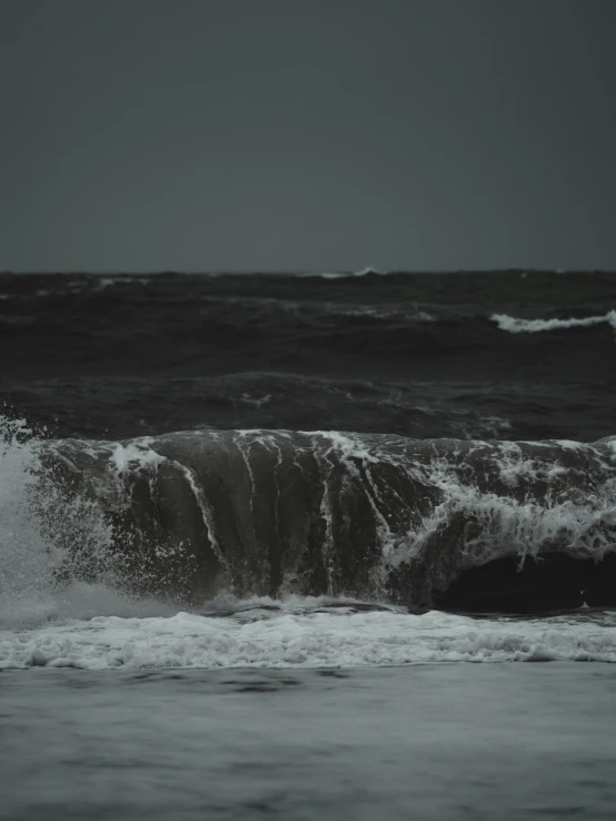 a wave is coming in over the water