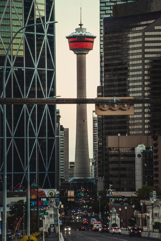 a street in front of tall buildings and a tower