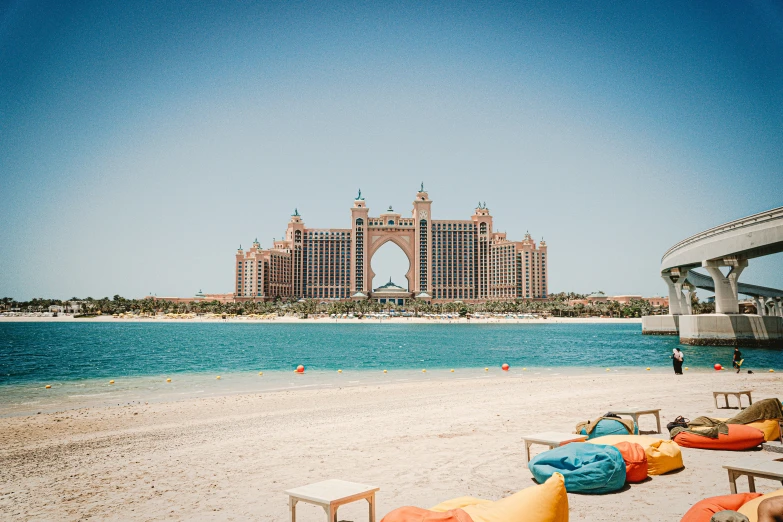 a beach with an arch in the background