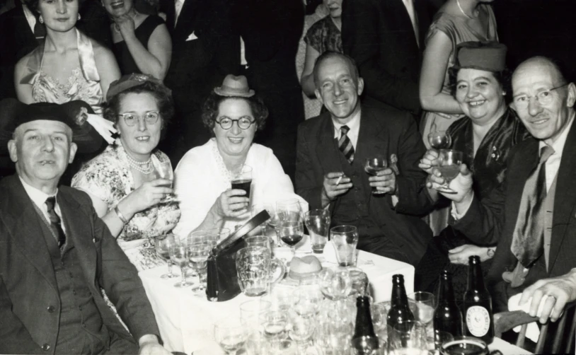 black and white po of people with hats, glasses, and drinking alcohol