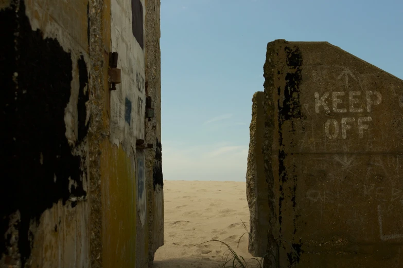 two concrete blocks in the sand near one another