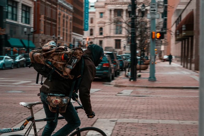 the person is riding his bike down the street