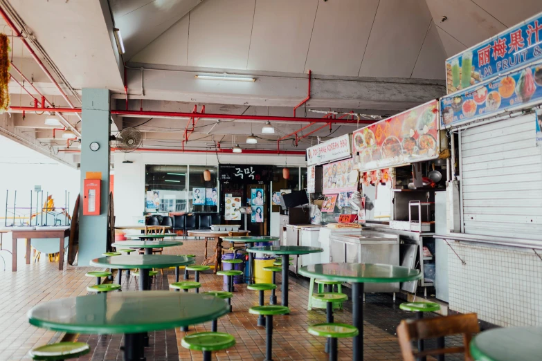 a restaurant filled with lots of green tables