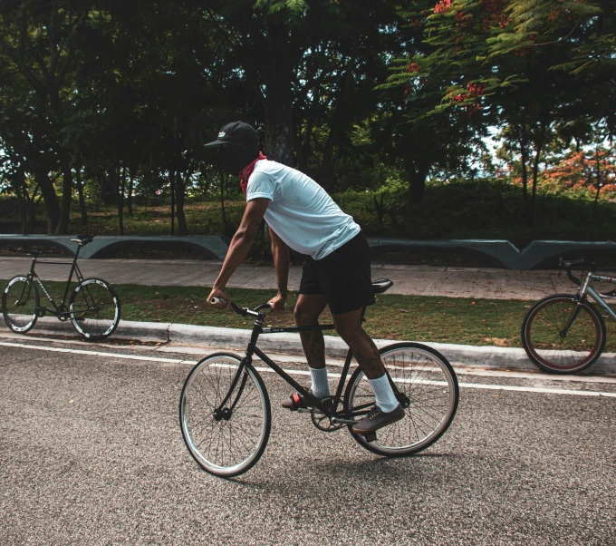 an individual is getting ready to ride their bike