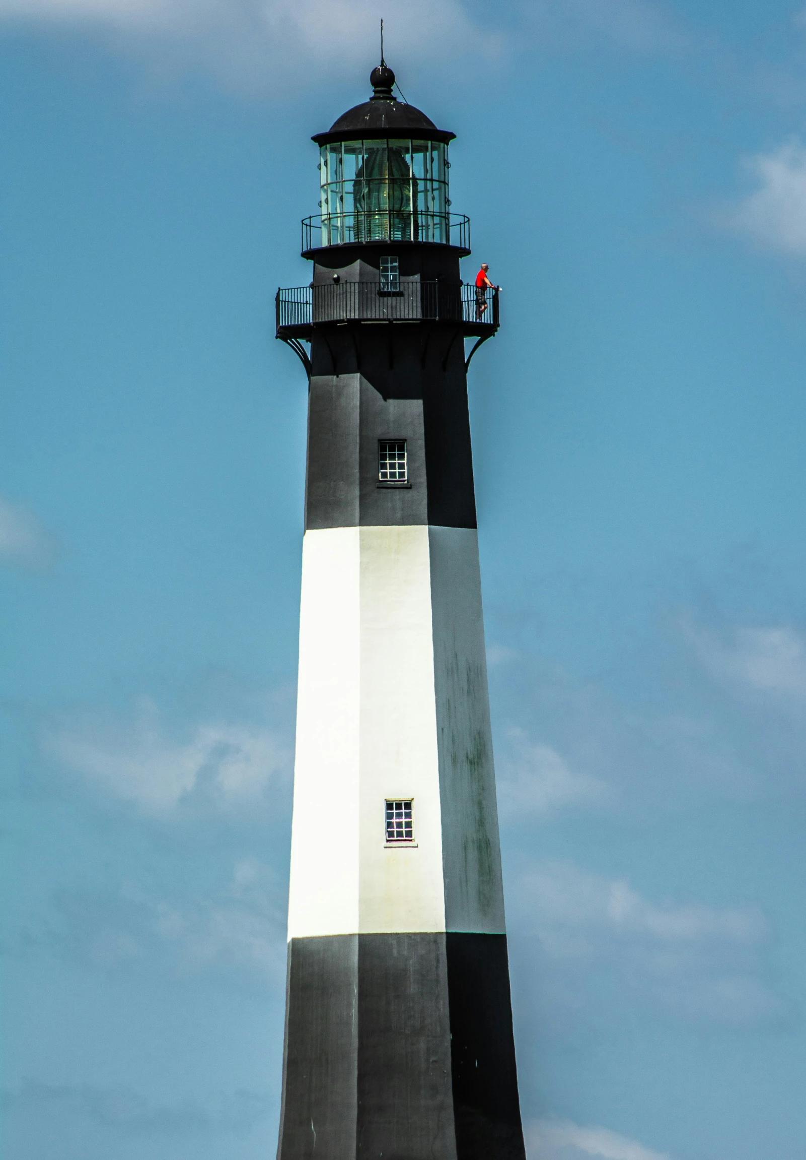 the white and black striped lighthouse looks like it has a little red on it