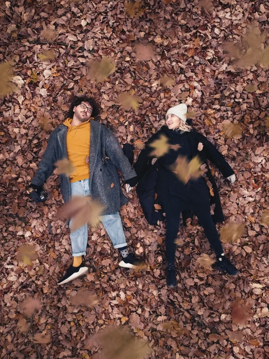 two people that are laying down on the ground