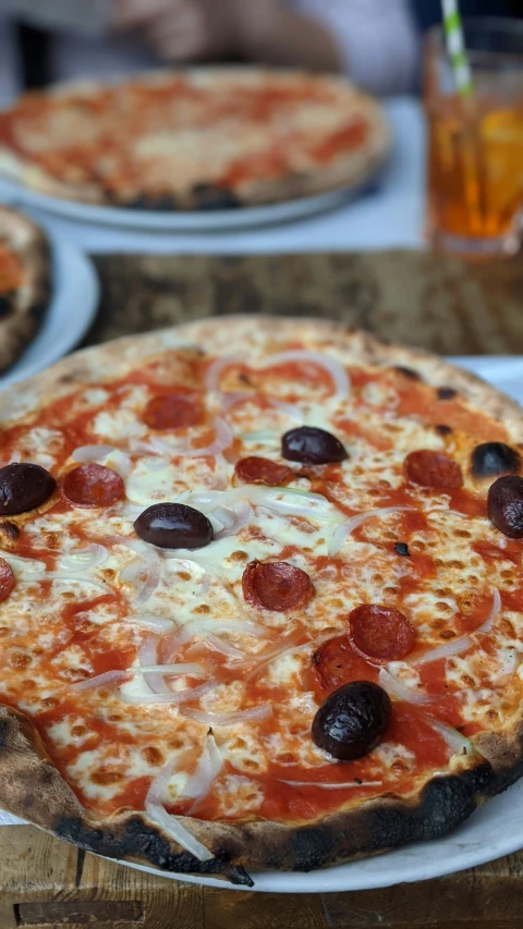 two slices of pizza are on white plates