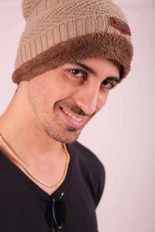 a man is wearing a beanie and posing