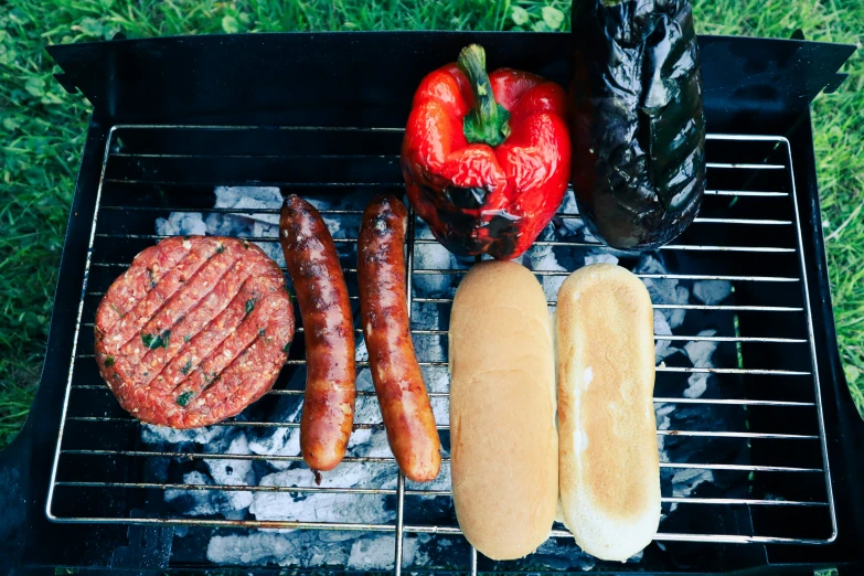 food cooking on a grill outside in the grass