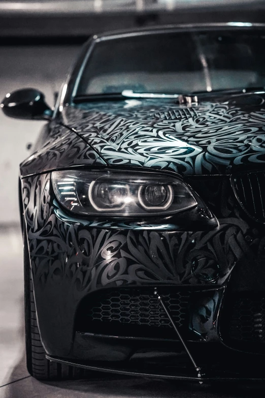 a bmw car with the hoods covered in black and white print