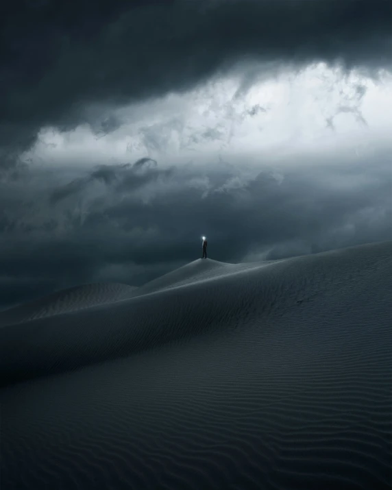 a lone person stands in a stormy desert