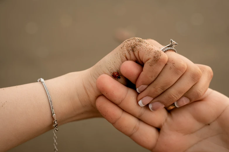 the man is holding the woman's hand close together