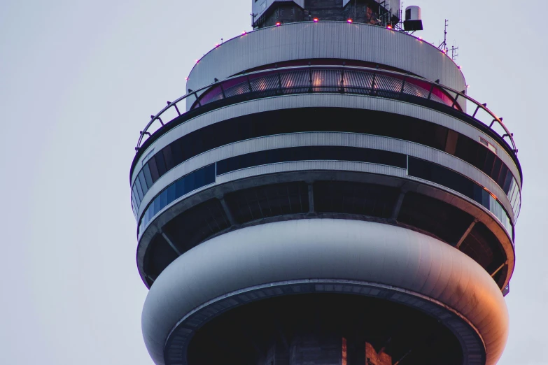 a tall tower with several birds sitting on top