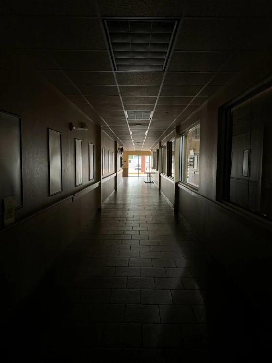 the long hallway has an open door on both sides