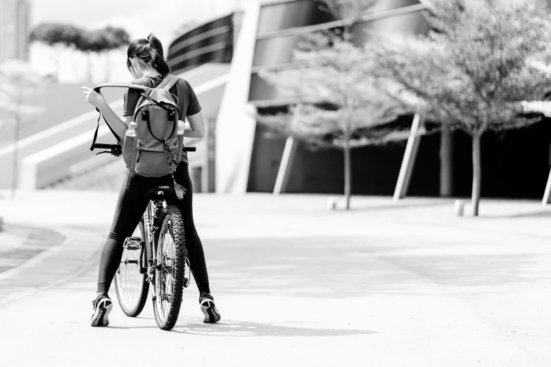 the person is riding a bike holding a book