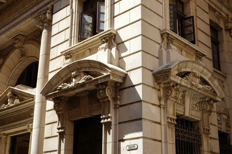 the front of an old building has arched columns and stonework