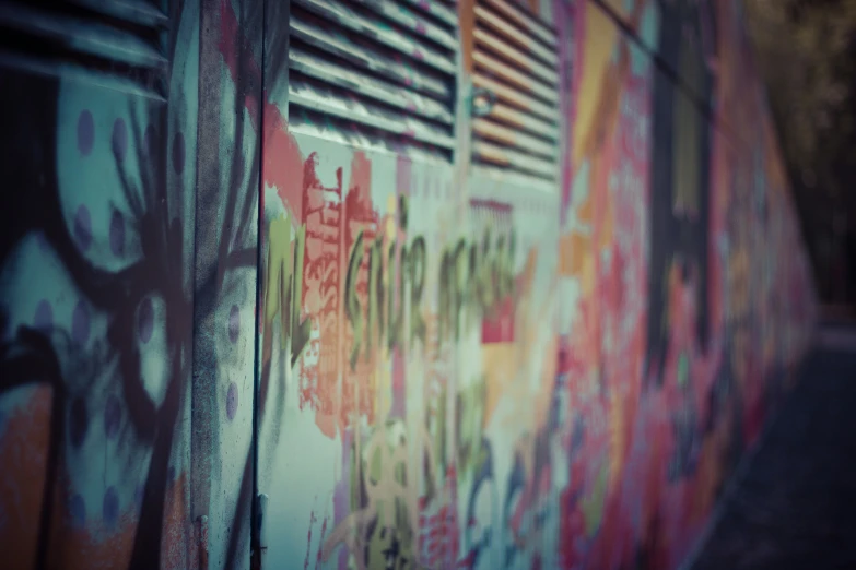 a wall with graffiti on it with a window coverings