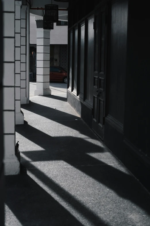 shadows of a light in the middle of a hallway