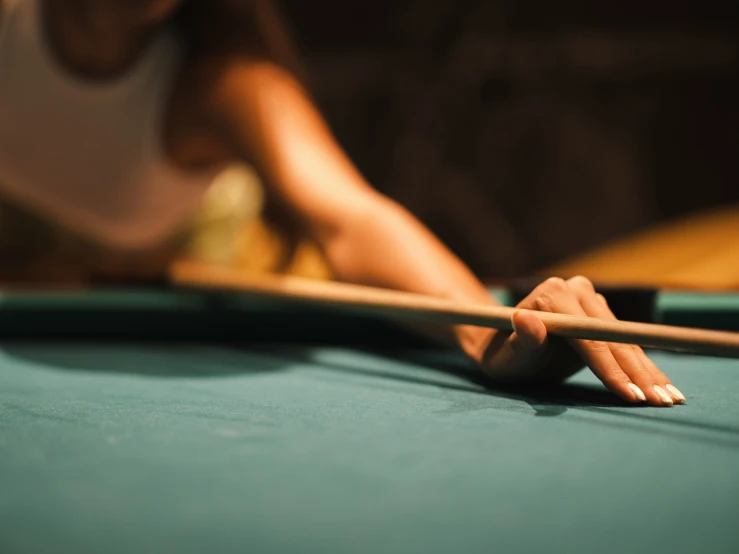 a pool bill table with a hand resting on the pool board