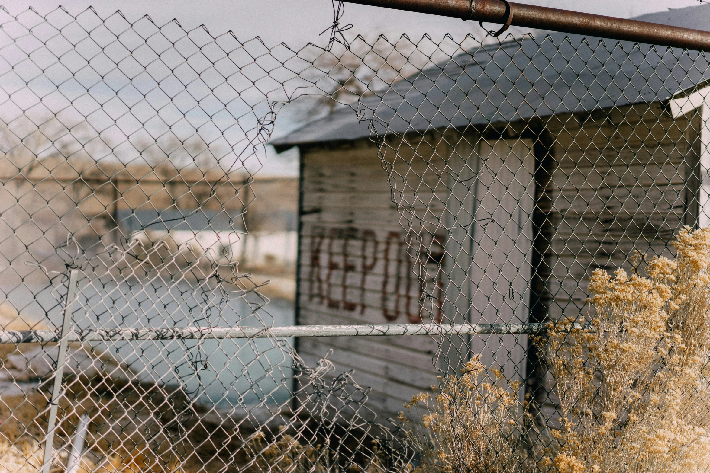 a small fence next to an old shack