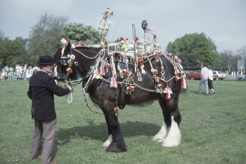 a man is walking with a decorated horse