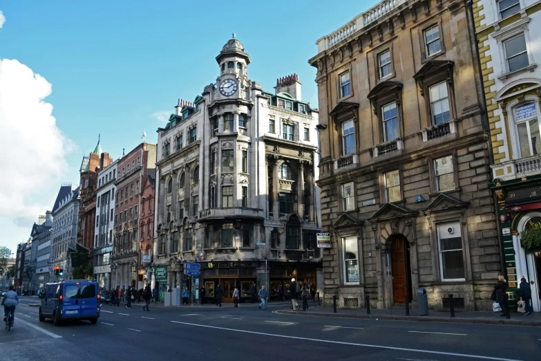 two vehicles are parked on the street in front of some buildings