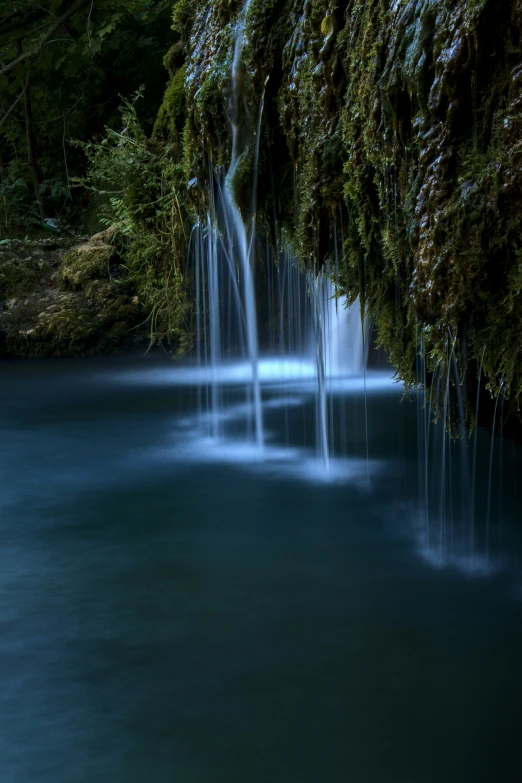 many small waterfalls are lined up in the middle of a blue river