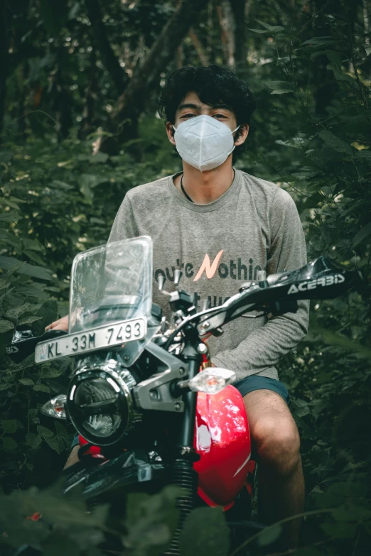 man on a motorcycle wearing a mask during the day