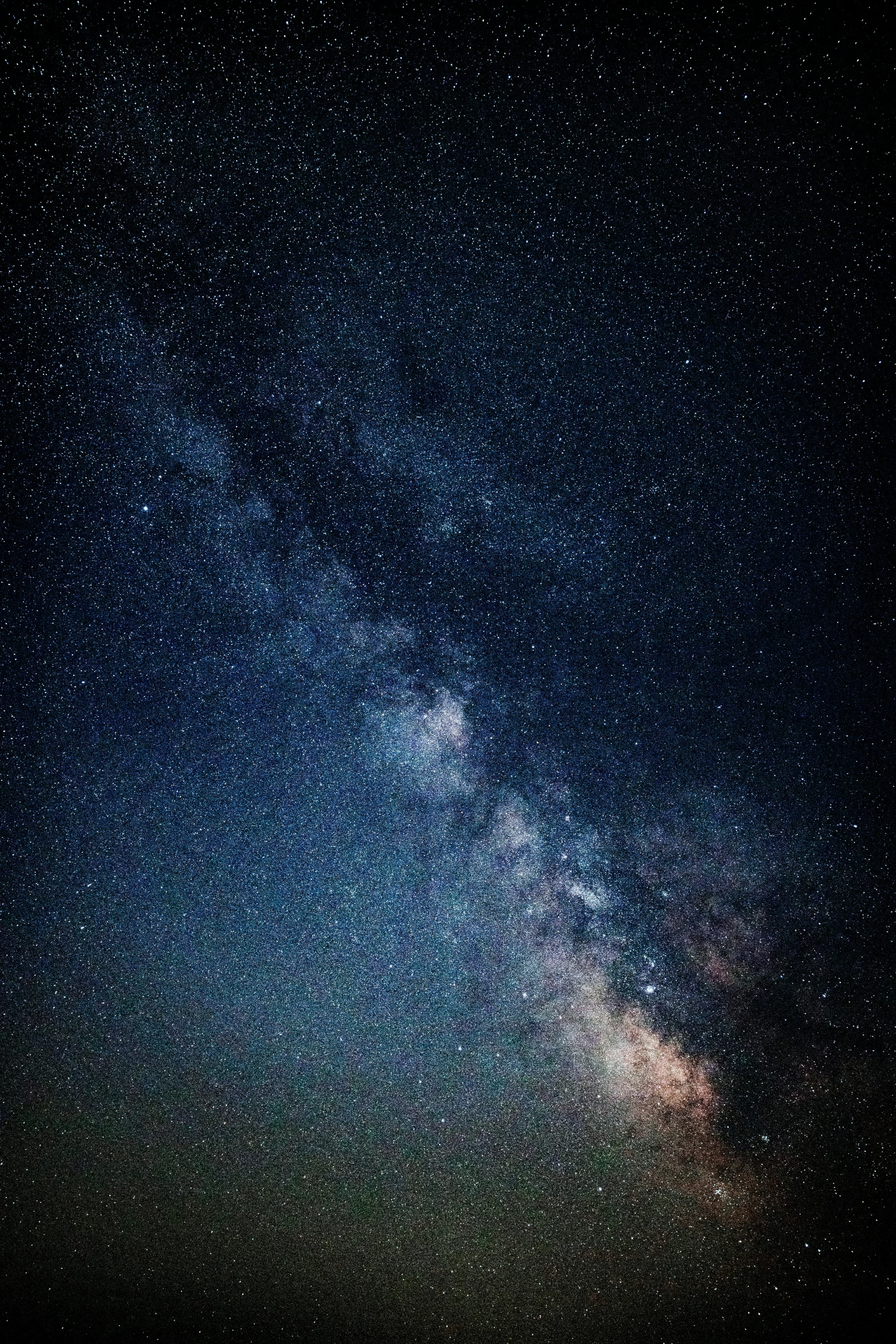 the night sky with many stars over a field